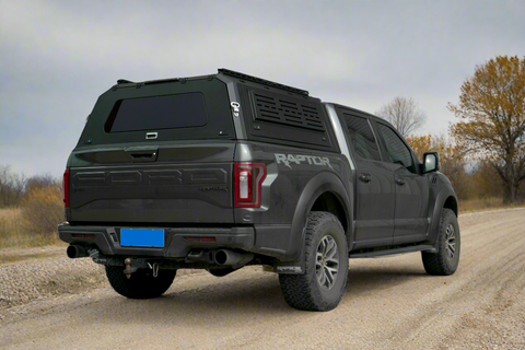 Side view of heavy-duty steel truck topper on black pickup
Modular canopy with open gullwing side door
Lockable utility cap rear view
Installation components of modular truck canopy
Steel topper installed on full-size pickup truck