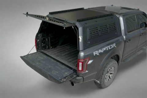 Side view of heavy-duty steel truck topper on black pickup
Modular canopy with open gullwing side door
Lockable utility cap rear view
Installation components of modular truck canopy
Steel topper installed on full-size pickup truck