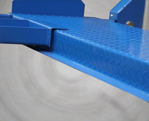 Blue portable 4-post car hoist in garage
Drive-on ramp and runway surface
Close-up of power unit and lift columns
Vehicle elevated on blue car lift
Heavy-duty safety locks and cable system