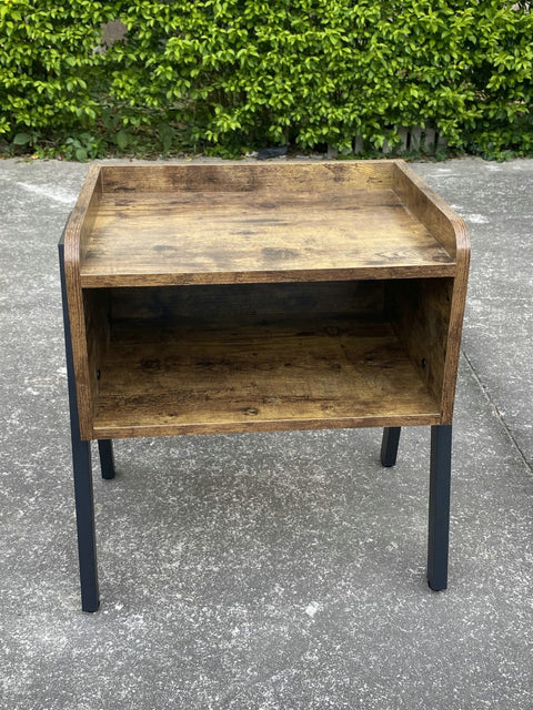 Stackable rustic wood and metal nightstand in bedroom
Industrial bedside table with black metal legs
Dual-tier MDF nightstand in modern space
Wooden nightstand stacked for storage
Compact rustic nightstand for small room