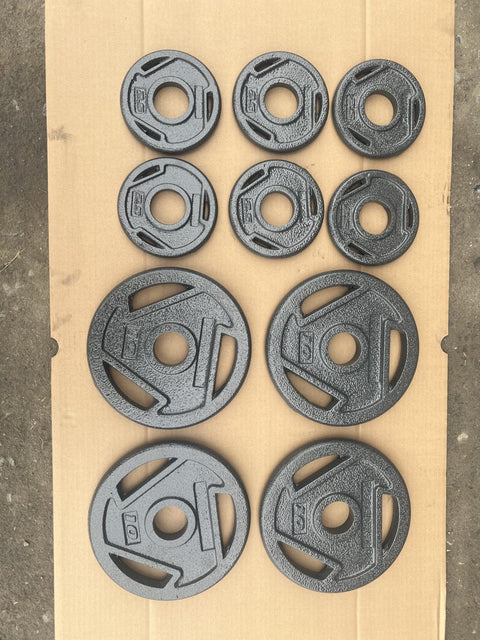 10-piece set of Olympic weight plates – 55 lb cast iron
Grip hole weight plates for Olympic barbells – black enamel finish
Heavy-duty Olympic barbell plates – commercial gym set
Close-up of cast iron 2.5 lb and 10 lb weight plates
Black Olympic weight plates stacked with 2-inch holes