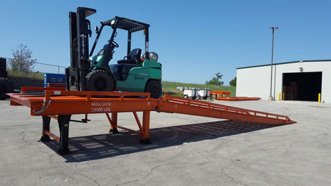 Side view of red adjustable steel dock ramp for trucks