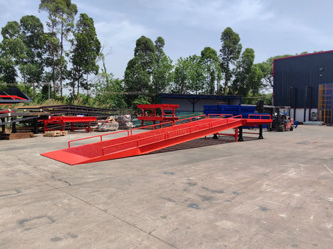 Heavy-duty loading dock ramp with red grating on asphalt yard
Forklift-compatible yard ramp side view with guardrails
Industrial dock ramp base plate and wheels
Side profile of 8 ft wide portable dock ramp
Ramp surface with serrated anti-slip steel close-up