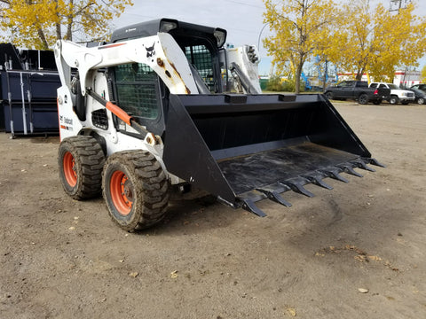 80" skid steer digging bucket with removable teeth
Heavy-duty bucket on job site with loader
Front view of 84-inch skid steer bucket
Skid steer digging into dirt with steel bucket
Wear strips and teeth close-up for material handling