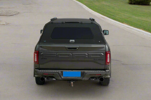 Side view of heavy-duty steel truck topper on black pickup
Modular canopy with open gullwing side door
Lockable utility cap rear view
Installation components of modular truck canopy
Steel topper installed on full-size pickup truck