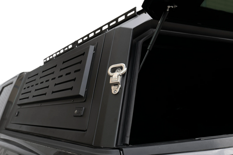 Side view of heavy-duty steel truck topper on black pickup
Modular canopy with open gullwing side door
Lockable utility cap rear view
Installation components of modular truck canopy
Steel topper installed on full-size pickup truck