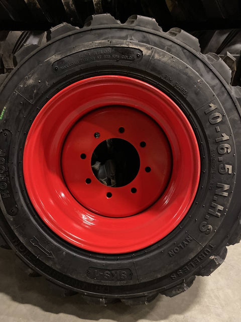 “Heavy duty skid steer tires with aggressive tread”
“SKS-1 and SKS-4 tires for Bobcat A300 and S750”
“Skid steer tires with red and silver rims”
“10x16.5 to 15x19.5 skid steer tire variants”
“Close-up of durable construction skid steer tire”