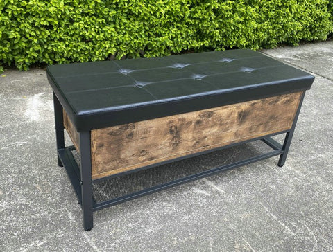 "Industrial Chesterfield-style storage bench ottoman with black metal frame, faux leather tufted top, and hidden trunk storage – Model TSLB2110"