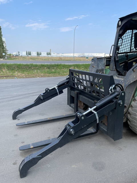 Front view of skid steer pipe grapple with clamp arms
Side view showing 48-inch clamp arm forks in use
Pipe grapple lifting construction material
Close-up of dual hydraulic clamp system