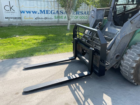 Front view of skid steer pipe grapple with clamp arms
Side view showing 48-inch clamp arm forks in use
Pipe grapple lifting construction material
Close-up of dual hydraulic clamp system