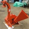 Front view of BX42T 3-point wood chipper attachment
Side profile showing 25" chipping disk on BX42T
Close-up of chipper blades and discharge chute
BX42T wood chipper connected to tractor PTO