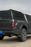 Side view of heavy-duty steel truck topper on black pickup
Modular canopy with open gullwing side door
Lockable utility cap rear view
Installation components of modular truck canopy
Steel topper installed on full-size pickup truck