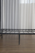 Metal platform bed frame assembled on wooden floor in modern space