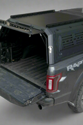 Side view of heavy-duty steel truck topper on black pickup
Modular canopy with open gullwing side door
Lockable utility cap rear view
Installation components of modular truck canopy
Steel topper installed on full-size pickup truck