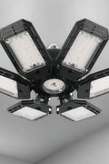 Foldable LED ceiling lights with multi-angle illumination in garage