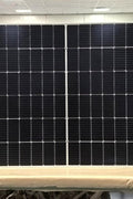 "565W bifacial monocrystalline solar panel front view"
"144-cell high-efficiency solar module close-up"
"Solar panel showing rear energy capture and wiring"
"Commercial-grade bifacial solar panel in warehouse"