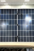 "565W bifacial monocrystalline solar panel front view"
"144-cell high-efficiency solar module close-up"
"Solar panel showing rear energy capture and wiring"
"Commercial-grade bifacial solar panel in warehouse"