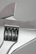 Close-up of adjustable crescent wrench wide-opening jaw and chrome polished surface