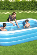 Bestway inflatable rectangular paddling pool with family inside

Top-down view of Bestway blue inflatable pool

Inflatable pool on grass with children playing

Side angle of Bestway pool showing two air chambers

Dimensions of Bestway family pool

Family enjoying inflatable pool in the backyard

Rectangular Bestway paddling pool setup outdoors