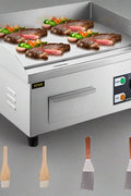 Stainless steel 14-inch electric countertop griddle with eggs and vegetables
30-inch commercial electric flat-top grill with accessories
Non-stick restaurant griddle with oil drain system
Electric griddle set with spatulas and splash guard
Heavy-duty commercial griddle for diner use