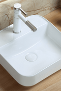 Modern countertop bathroom sink basin in white ceramic
Above counter square vessel sink installed on wooden vanity
Bathroom vanity bowl with chrome faucet and soap dispenser
Dimensions of square countertop sink with standard drain hole
Side and top view of glossy white vessel sink for powder room