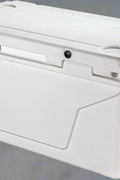Underside of 110 QT rolling cooler highlighting wheelbase and drainage system