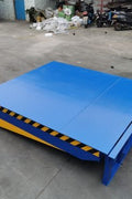 Powered dock leveler showing hydraulic control panel