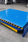 Electric dock leveler ramp with blue powder-coated finish