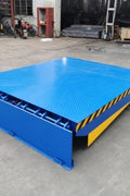 Side view of 20,000 lb electric dock ramp at warehouse