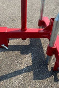 Red 3-point gooseneck hitch with bale spear mount
Tractor trailer hitch attachment with hay spear slots
Reinforced hitch frame for Conus 2 and Conus 1 spear placement
3-point trailer hitch attachment mounted on tractor
Spear holes and 2” trailer receiver on attachment frame