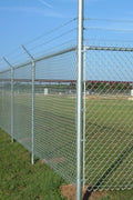 500 ft galvanized chain link fence with dual gates and barbed wire
Chain link security fence installation on a grass field
Close-up of barbed wire mounted on a galvanized post
Heavy-duty steel fence post and gate system
Wide-angle view of assembled fence perimeter kit