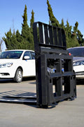 Side view of 5000 lb side shift pallet forks for skid steer

Heavy-duty hydraulic pallet fork with side shift mechanism

Pallet fork attachment mounted on forklift outdoors

Black steel frame skid steer pallet forks with side shift

Industrial pallet forks for warehouse and yard use