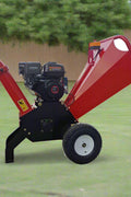 6.5 HP Wood Chipper with Briggs & Stratton engine – side view
Red GS100 wood chipper – front chute and wheels
Compact gasoline-powered wood chipper in garage setup
Rear view of GS100 chipper with large discharge chute