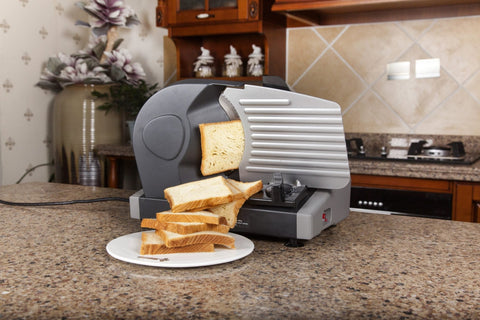 7.5 inch electric meat and deli slicer on kitchen counter
Adjustable food thickness dial and stainless steel blade
Compact electric slicer with food pusher in use
Top view of food slicer showing aluminum body
Deli meat sliced using electric food cutter