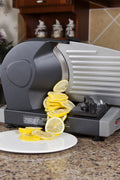 7.5 inch electric meat and deli slicer on kitchen counter
Adjustable food thickness dial and stainless steel blade
Compact electric slicer with food pusher in use
Top view of food slicer showing aluminum body
Deli meat sliced using electric food cutter