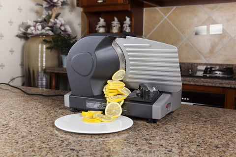 7.5 inch electric meat and deli slicer on kitchen counter
Adjustable food thickness dial and stainless steel blade
Compact electric slicer with food pusher in use
Top view of food slicer showing aluminum body
Deli meat sliced using electric food cutter