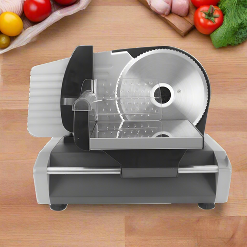 7.5 inch electric meat and deli slicer on kitchen counter
Adjustable food thickness dial and stainless steel blade
Compact electric slicer with food pusher in use
Top view of food slicer showing aluminum body
Deli meat sliced using electric food cutter