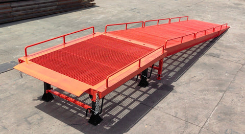 Heavy-duty loading dock ramp with red grating on asphalt yard

Forklift-compatible yard ramp side view with guardrails

Industrial dock ramp base plate and wheels

Side profile of 8 ft wide portable dock ramp

Ramp surface with serrated anti-slip steel close-up