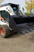 80" skid steer digging bucket with removable teeth

Heavy-duty bucket on job site with loader

Front view of 84-inch skid steer bucket

Skid steer digging into dirt with steel bucket

Wear strips and teeth close-up for material handling