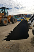 80" skid steer digging bucket with removable teeth

Heavy-duty bucket on job site with loader

Front view of 84-inch skid steer bucket

Skid steer digging into dirt with steel bucket

Wear strips and teeth close-up for material handling