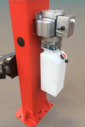 Red 2-post car hoist installed in garage

Close-up of safety lock and lift arms

Base of the lift showing manual release system

Top bar and symmetrical arm configuration