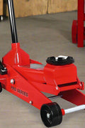 Big Red Steel Floor Jack – 2 Ton Hydraulic Lift Tool
Low Profile Red Garage Jack – Model T83502
Hydraulic Car Jack with Pedal and Casters
Heavy-Duty Vehicle Jack – Wide Base Support
Close-Up of Floor Jack Casters and Lifting Arm