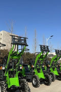 CanLift Lithium Electric Wheel Loader – Front View with Bucket
Green eco-friendly CanLift wheel loader on grass lot with trailer