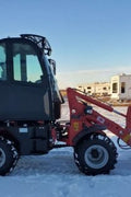 CanLift W12 Mini Wheel Loader with Kohler diesel engine outside a facility
Side view of CanLift W12 loader equipped with bucket attachment
Compact CanLift W12 Wheel Loader used on farm site
