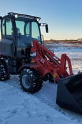 CanLift W12 Mini Wheel Loader with Kohler diesel engine outside a facility
Side view of CanLift W12 loader equipped with bucket attachment
Compact CanLift W12 Wheel Loader used on farm site