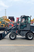 CanLift W12 Mini Wheel Loader with Kohler diesel engine outside a facility
Side view of CanLift W12 loader equipped with bucket attachment
Compact CanLift W12 Wheel Loader used on farm site
