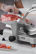 Professional-grade meat slicer cutting ham, cheese, and bread