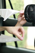 Passenger enjoying rear airflow from adjustable dual head car fan in sedan backseat
