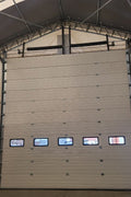 White insulated electric overhead garage door installed in shop
Heavy-duty motorized overhead garage door with steel frame
Electric garage door kit with insulation for industrial buildings
Overhead sectional garage door installed on warehouse