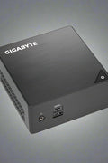 GIGABYTE BRIX mini PC with packaging
Intel Celeron J4105 mini desktop front view
Rear ports of BRIX GB-BLCE-4105 including HDMI, Ethernet, USB
Internal layout showing M.2 and 2.5” storage support
Ultra-compact BRIX mini PC on desk with monitor